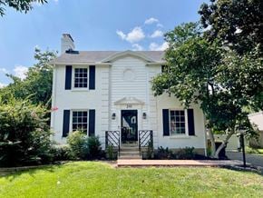 Louisville house for rent - a white house with black shutters and a lawn and trees