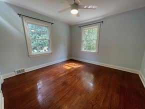 Louisville house for rent - an empty bedroom with wood floors and a ceiling fan