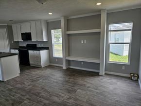 Shawnee house for rent - A kitchen with a black countertop and white cabinets.