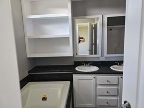 Shawnee house for rent - A bathroom with a white sink and a white cabinet.