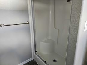 Shawnee house for rent - A white door with a handle and a small drain in the bottom.