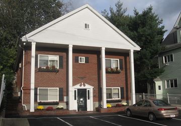 Stoneham apartment for rent - A white church with a car parked in front.