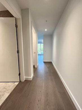 Vancouver apartment for rent - a hallway in a new home with white walls and wood flooring