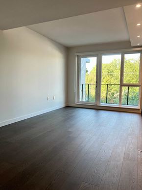 Vancouver apartment for rent - an empty living room with wood flooring and large windows