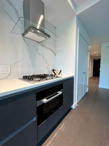 Vancouver apartment for rent - a black and white kitchen with a stove and oven