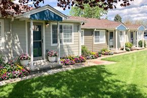 Arvada apartment for rent - an empty living room with wood floors and a blue door