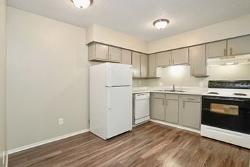 Longmont apartment for rent - the preserve at ballantyne commons apartment kitchen with white appliances and white cabinets
