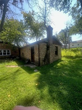 Saint Louis house for rent - a small brick house in a yard with grass and trees