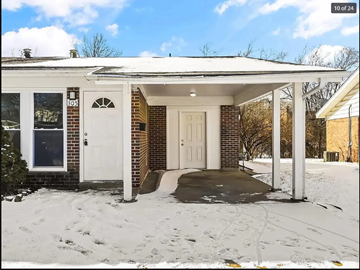 Florissant house for rent - the front door of a brick house in the snow