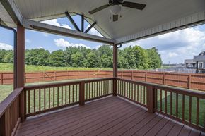 Clarksville house for rent - a covered porch with a view of a field and trees