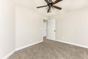 Clarksville house for rent - a bedroom with carpet and a ceiling fan