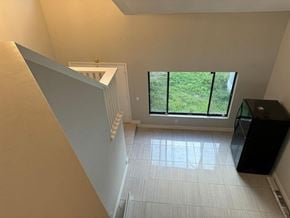 Orlando house for rent - a living room with a large window and a white tiled floor