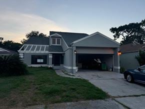 Orlando house for rent - a house with a car garage in front of it