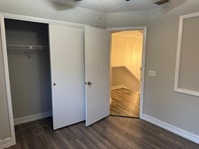 Orlando house for rent - a bedroom with two closets and a hallway with a door to a closet