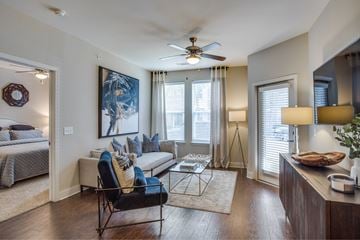 Flower Mound apartment for rent - A living room with a couch, chair, and a painting on the wall.