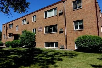 Moorhead apartment for rent - a brick building with green grass in front of it