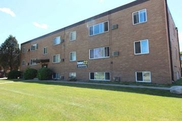 Moorhead apartment for rent - a large brick building with a lawn in front of it