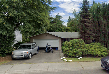 Kirkland house for rent - A silver truck is parked in front of a garage.