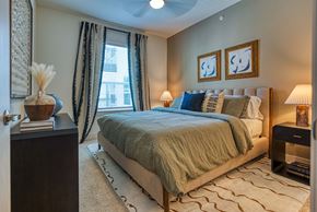 Dallas apartment for rent - a bedroom with a bed and a window