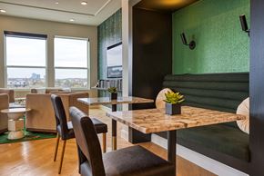 Dallas apartment for rent - a dining room with tables and chairs and a green wall