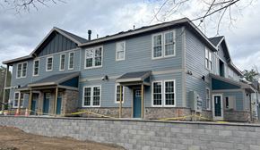 Clifton Park apartment for rent - a large blue house with a stone retaining wall