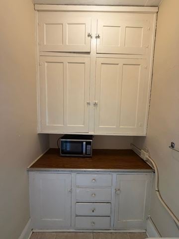 Grinnell apartment for rent - A microwave is sitting on a countertop in a kitchen.