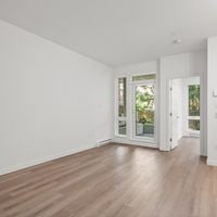 Victoria apartment for rent - A room with white walls and wooden flooring.