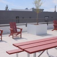Victoria apartment for rent - A red bench and chairs are on a patio.