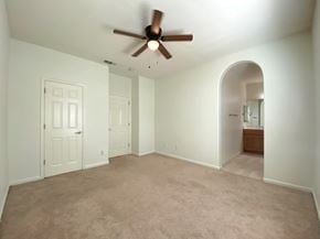 Merced house for rent - A room with a ceiling fan and carpeted floor.