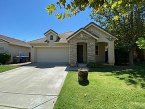 Merced house for rent - A house with a garage and a driveway.