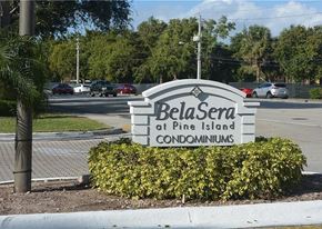 Plantation apartment for rent - A sign for BelaSera at Pine Island Condominiums is in front of a parking lot.