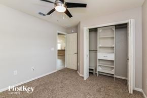 Winter Haven house for rent - a bedroom with a closet and a ceiling fan