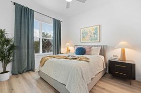 Austin apartment for rent - a bedroom with a bed and a large window