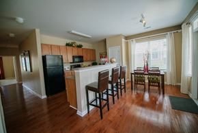 Indianapolis apartment for rent - Kitchen, energy star black appliances, hardwood floors, pantry, dining room table, kitchen island with three barstools