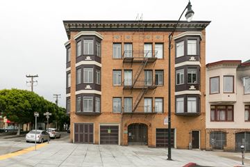 San Francisco apartment for rent - A large brick building with a fire escape on the side.