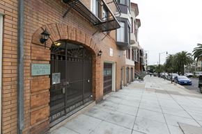 San Francisco apartment for rent - A brick building with a sign that says "Dolphin Apartments".