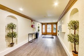 San Francisco apartment for rent - A hallway with wooden floors and white walls with arches.