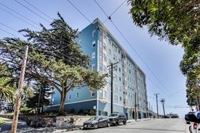 San Francisco apartment for rent - A blue building with a tree in front of it.