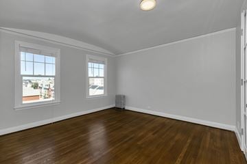 San Francisco apartment for rent - A room with wooden floors and two windows.