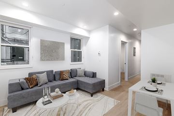 San Francisco apartment for rent - A living room with a grey couch and a white table.