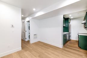 San Francisco apartment for rent - A kitchen with green cabinets and a white wall.