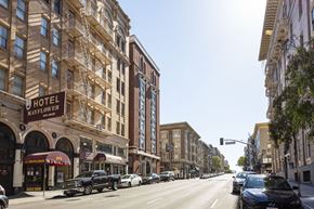 San Francisco apartment for rent - A street view of a city with cars parked on the side of the road and buildings on both sides.