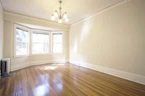 San Francisco apartment for rent - A room with a chandelier, hardwood floors, and a window.