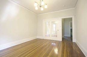 San Francisco apartment for rent - A room with wooden floors and a chandelier.