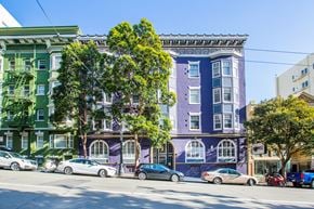San Francisco apartment for rent - A row of colorful buildings with cars parked in front.