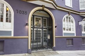 San Francisco apartment for rent - A purple building with a black gate and windows.