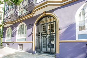 San Francisco apartment for rent - A purple building with a black gate and windows.