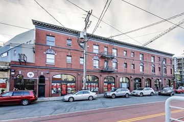 San Francisco apartment for rent - A red brick building with a black door and windows.