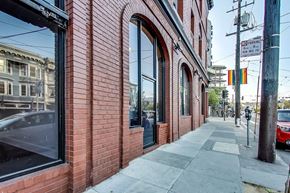 San Francisco apartment for rent - A red brick building with a sign that says "NO PARKING" on the sidewalk.