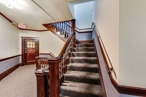 San Francisco apartment for rent - A staircase with a carpeted floor and wooden banister.
